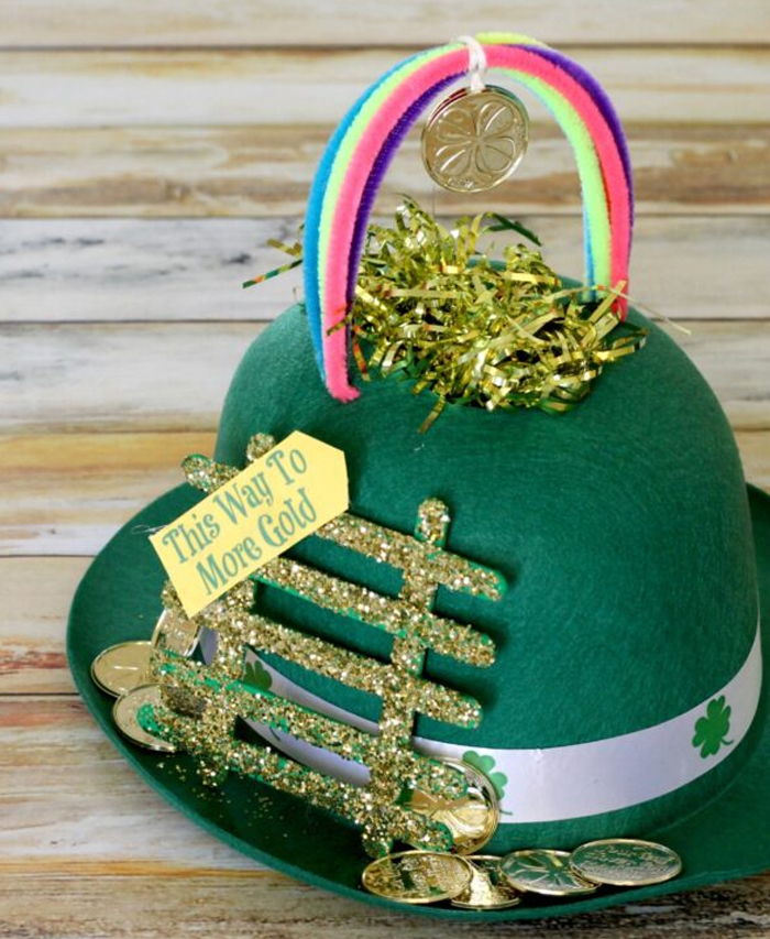 sparkly and glittery and gold leprechaun hat with stairs and a rainbow on top. Idea by funmoneymom