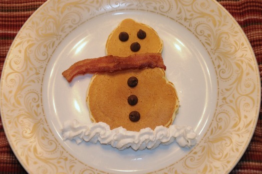 Decorate your snowman pancakes with whipped cream, bacon and chocolate chips