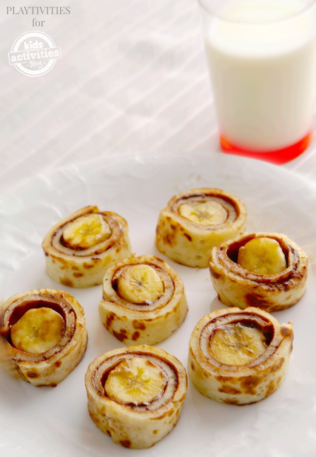ready-made pancake rolls recipe on a plate with a glass of milk for breakfast
