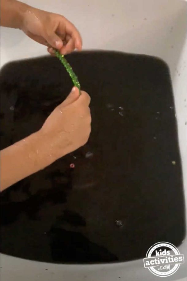 Black water in a tub to hide and seek in the tub with leftover Easter egg paint
