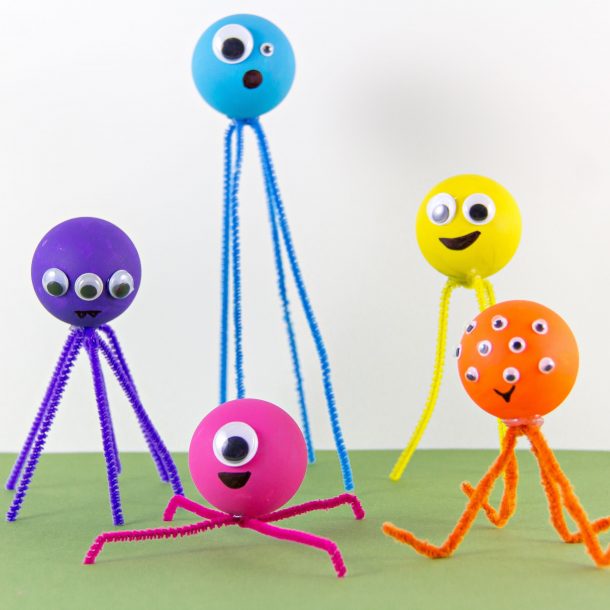 Make ping pong ball monsters - yellow monster with yellow pipe cleaner and google eyes, yellow ping pong ball with white pipe cleaners, blue ping pong ball with blue pipe cleaners and red pipe cleaner with red ping pong ball, pink ping pong ball with pink pipe cleaners