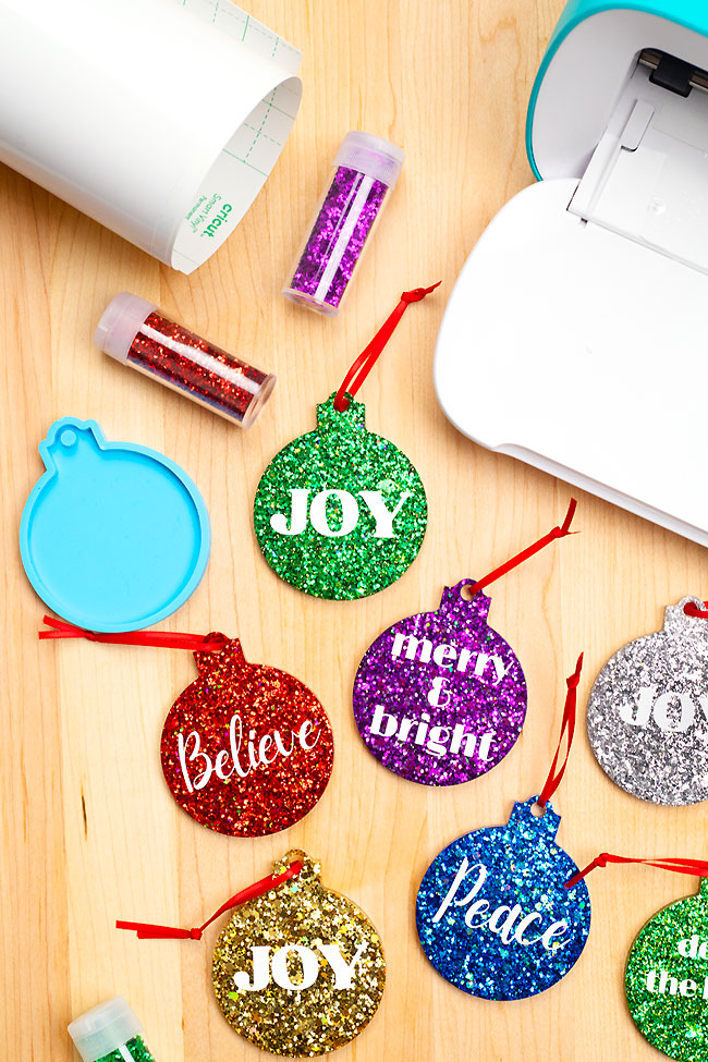 Resin Christmas ornaments with a silicone mold, glitter, and Cricut supplies