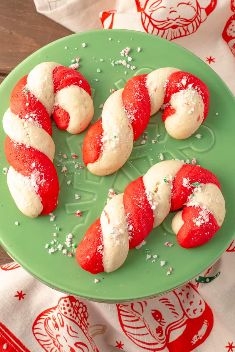 Candy cane cookies on a green plate.