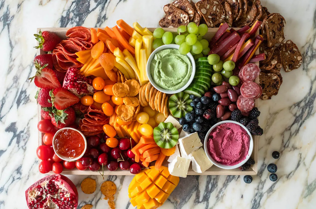 Food network Canada does rainbow with veggies, fruits, and meats. They include red, green, and purple dips. 