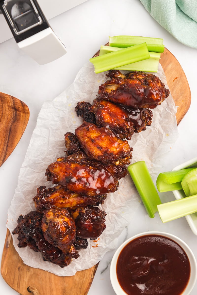 Overhead image of air fryer bbq chicken wings on a piece of parchment paper.