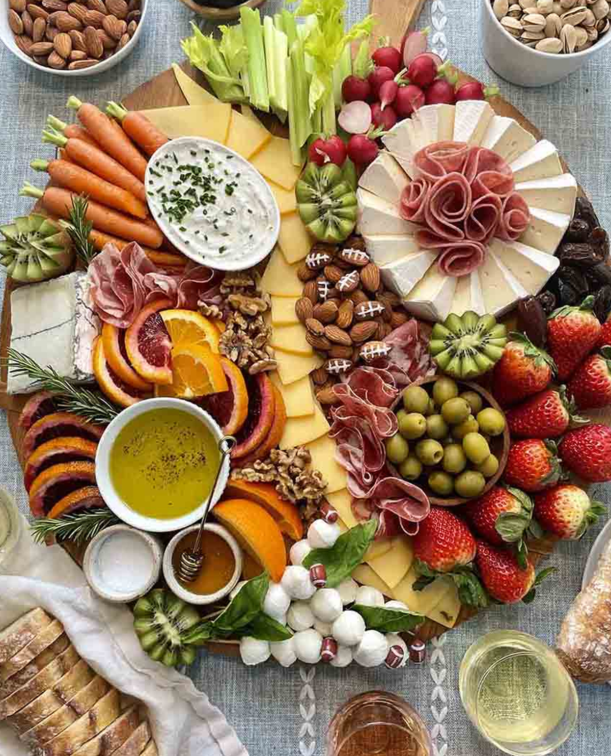 Ain't Too Proud To Meg's board showcases meats, cheese, veggies, nuts, and fruit.