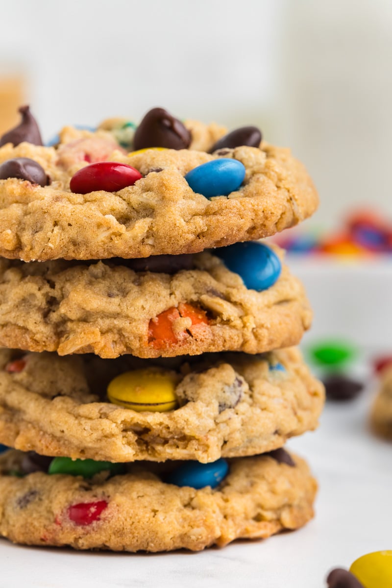 Stack of monster cookies on a plate.