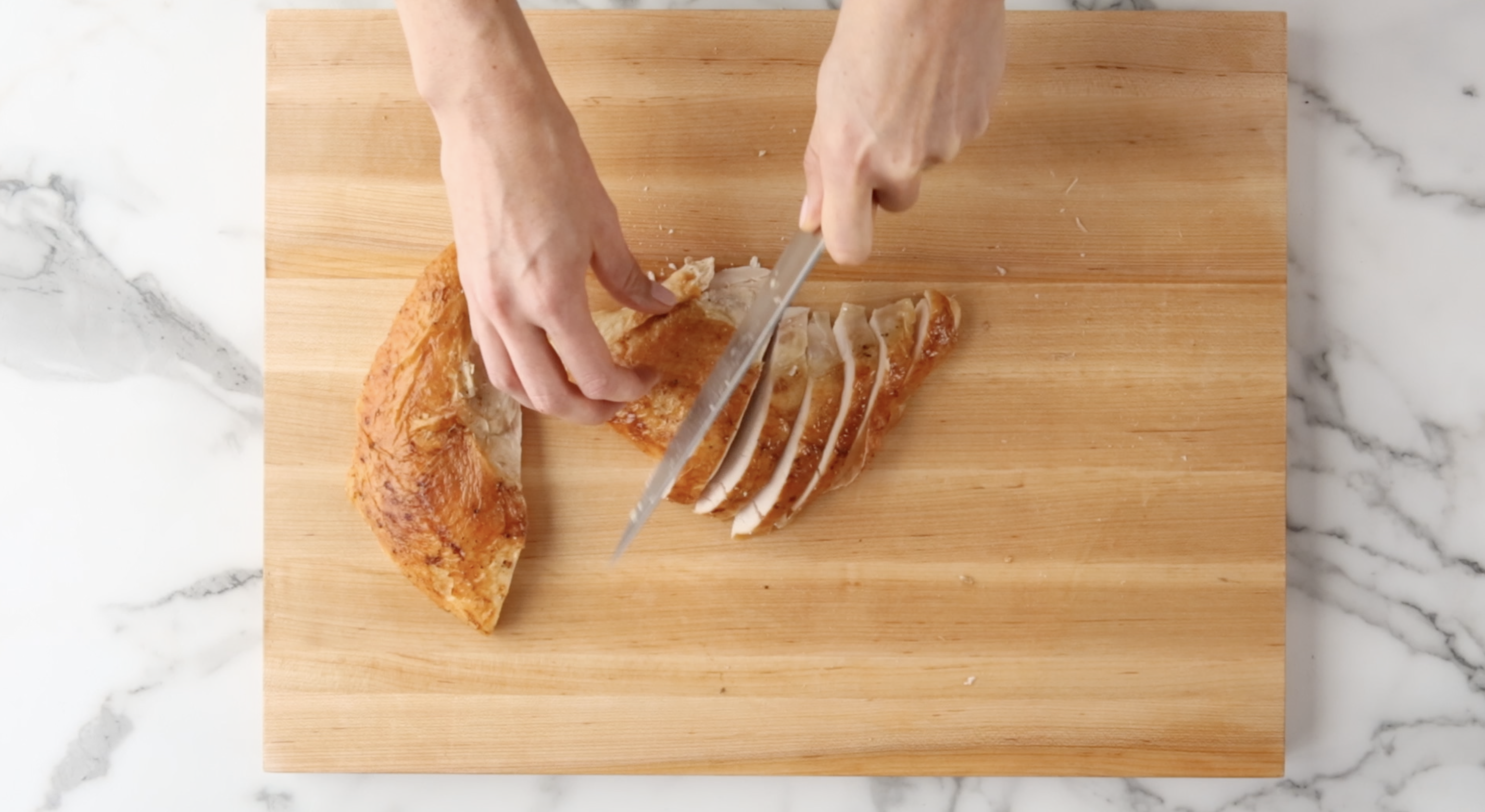Hand slicing turkey breast meat